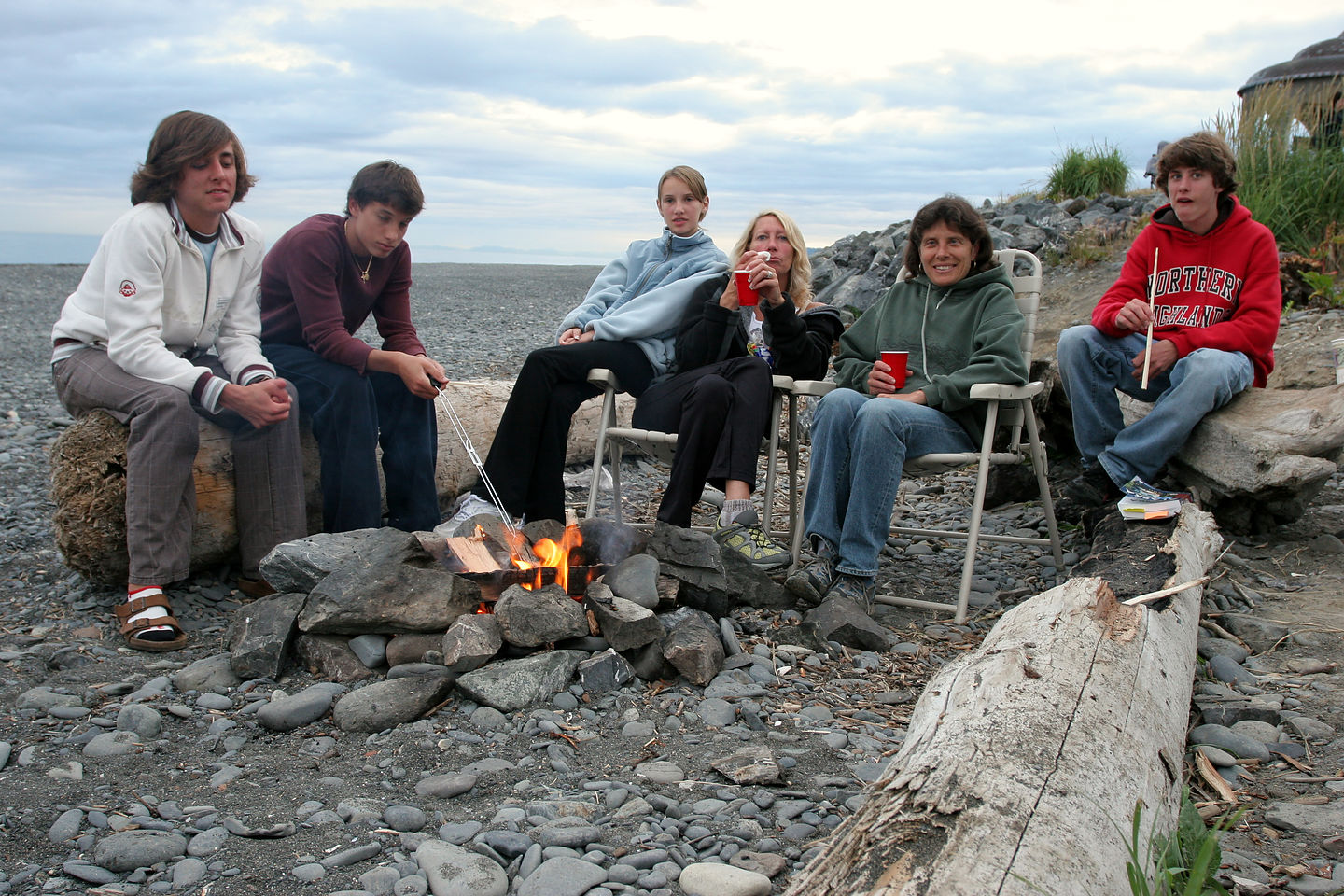 Gang roasting marshmallow around the campfire