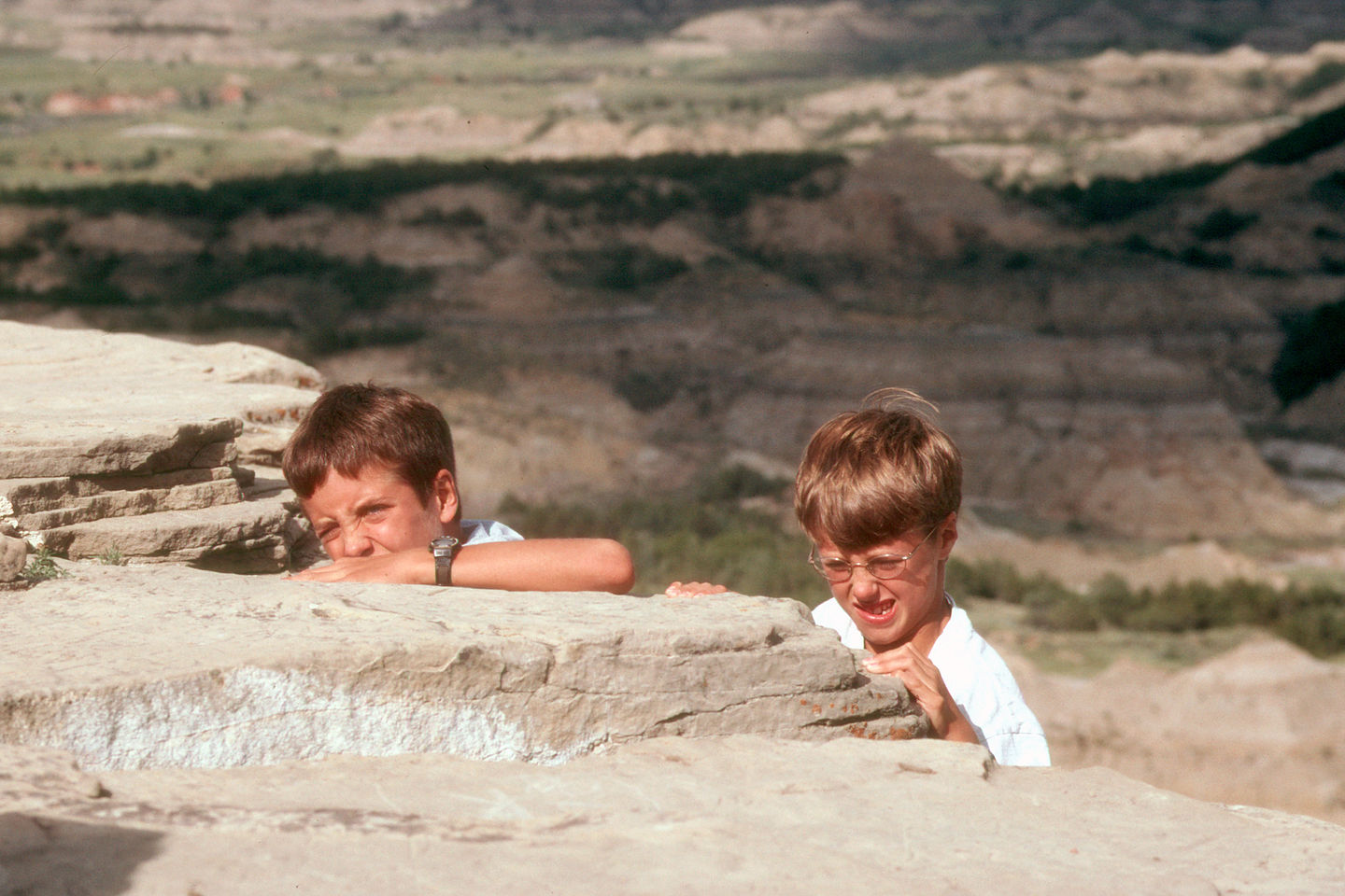 Boys climbing out of painted canyon