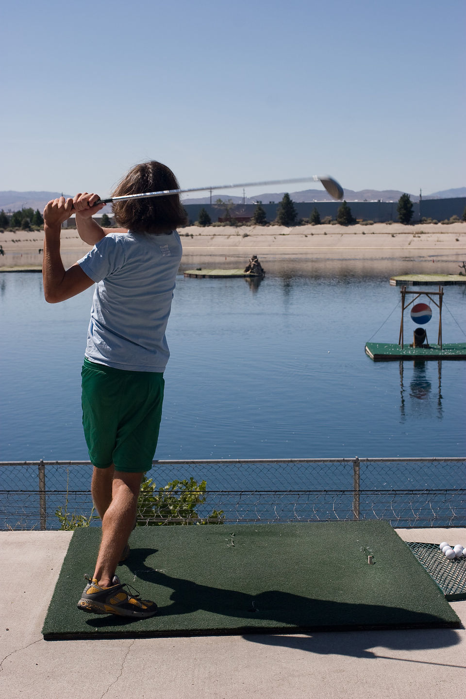 Andrew driving golf balls