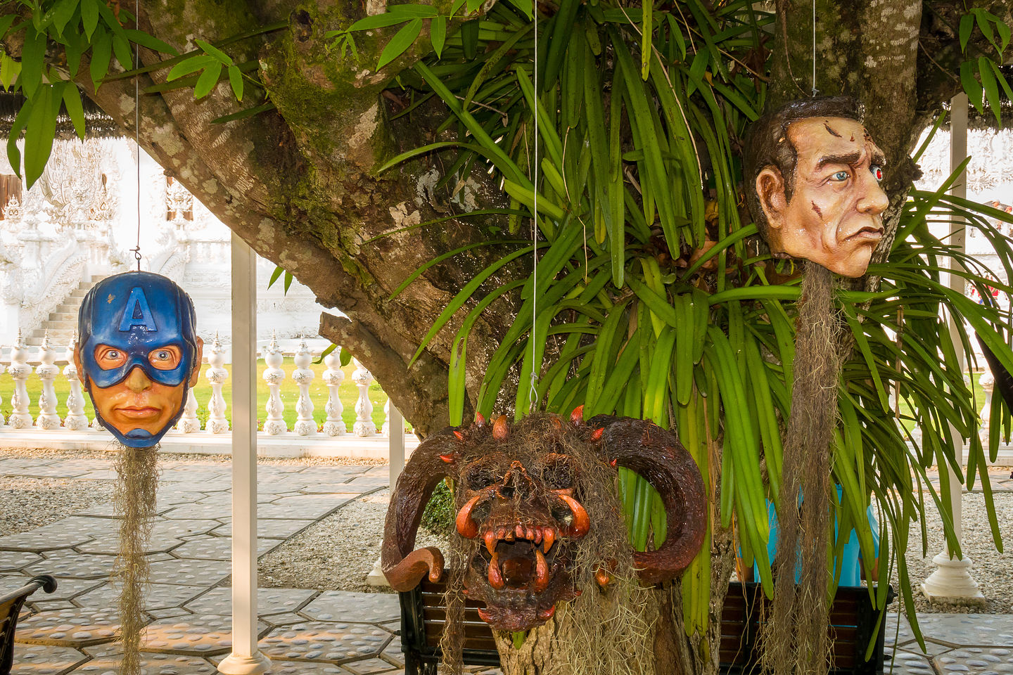 Creepy heads hanging from trees at the White Temple